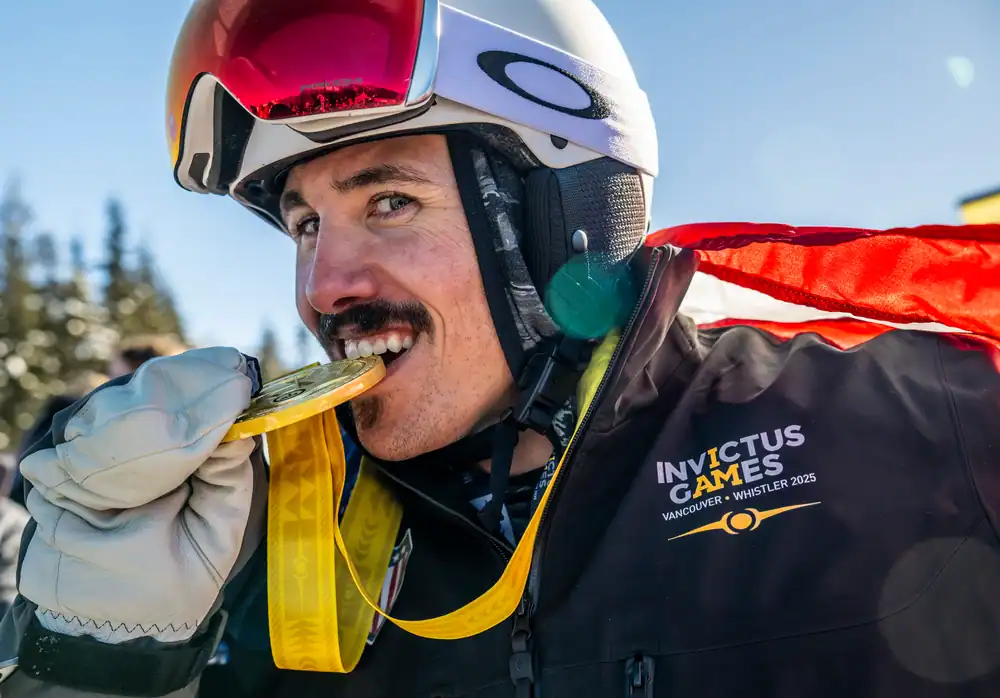 Albuquerque Academy student celebrating victory with medal at Invictus Games.