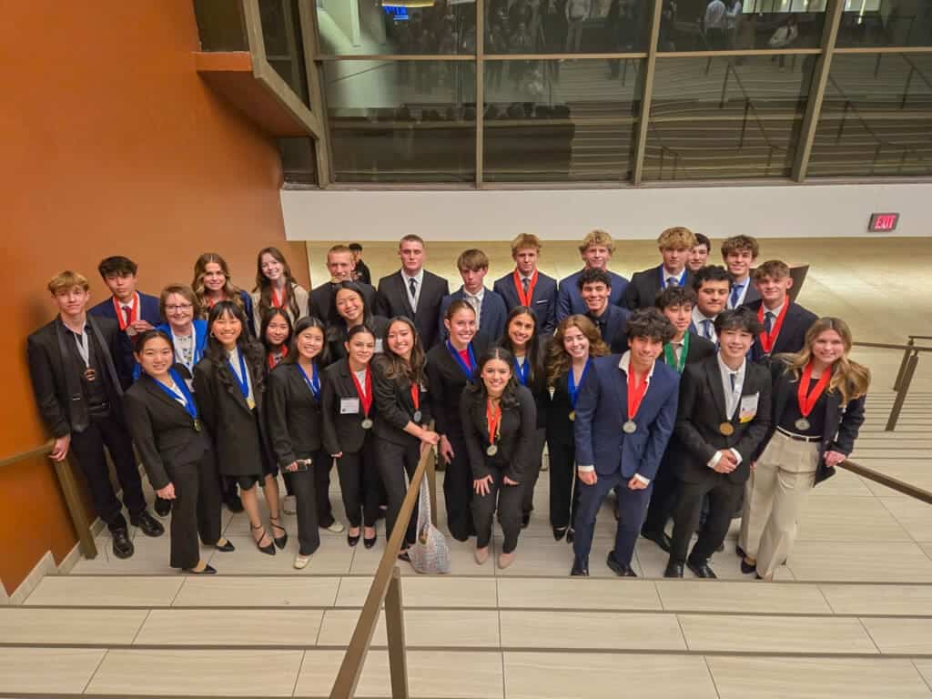 Albuquerque Academy students with medals at an academic event.
