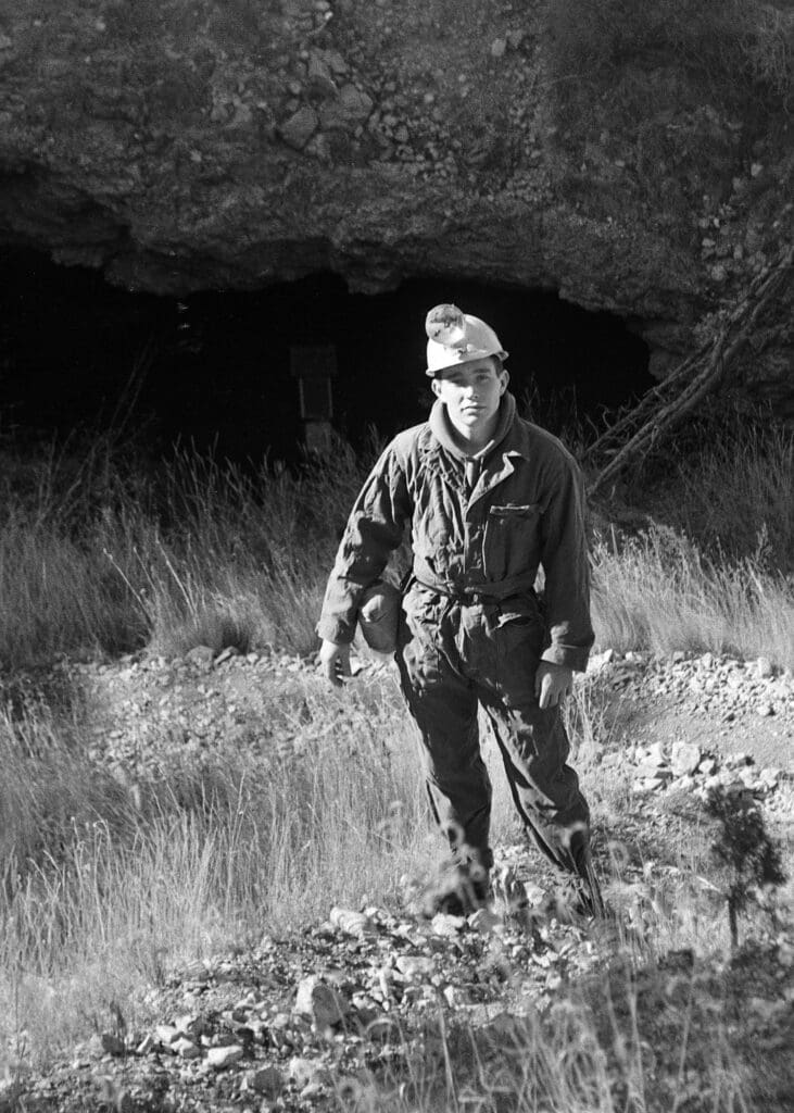 Young student exploring a nature or geology field trip outdoors at Albuquerque Academy.