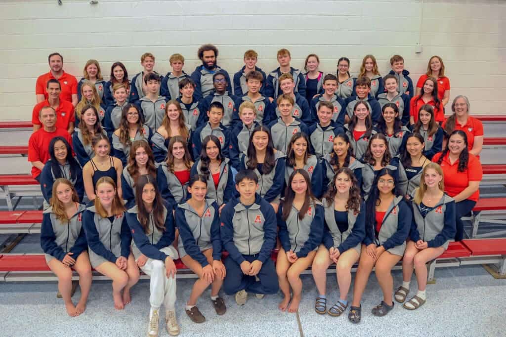 Albuquerque Academy student group photo in athletic uniforms, showcasing diverse students and faculty.