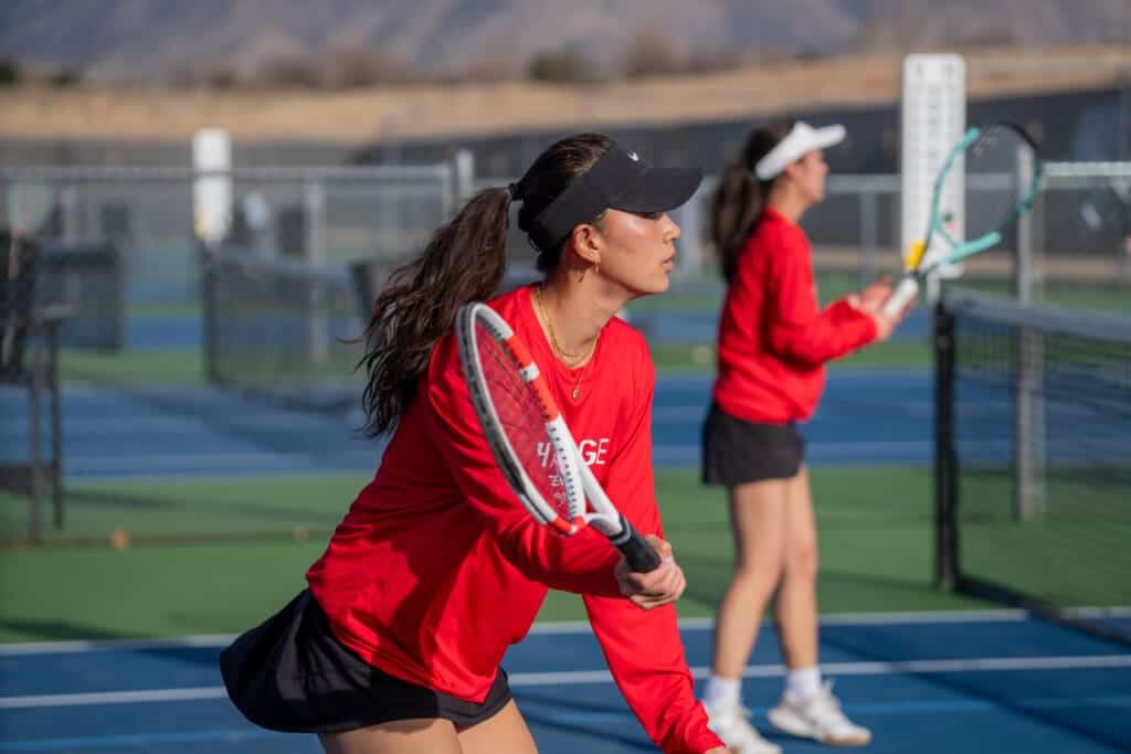 Albuquerque Academy tennis team practicing on outdoor courts in New Mexico.