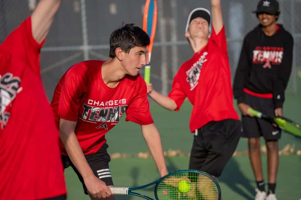 Students playing tennis on an outdoor court at Albuquerque Academy in New Mexico.
