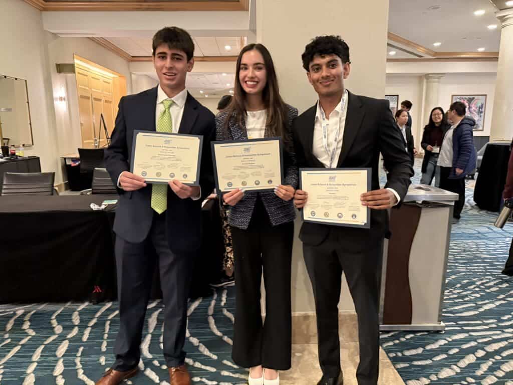 Honors students holding certificates at Albuquerque Academy science symposium.