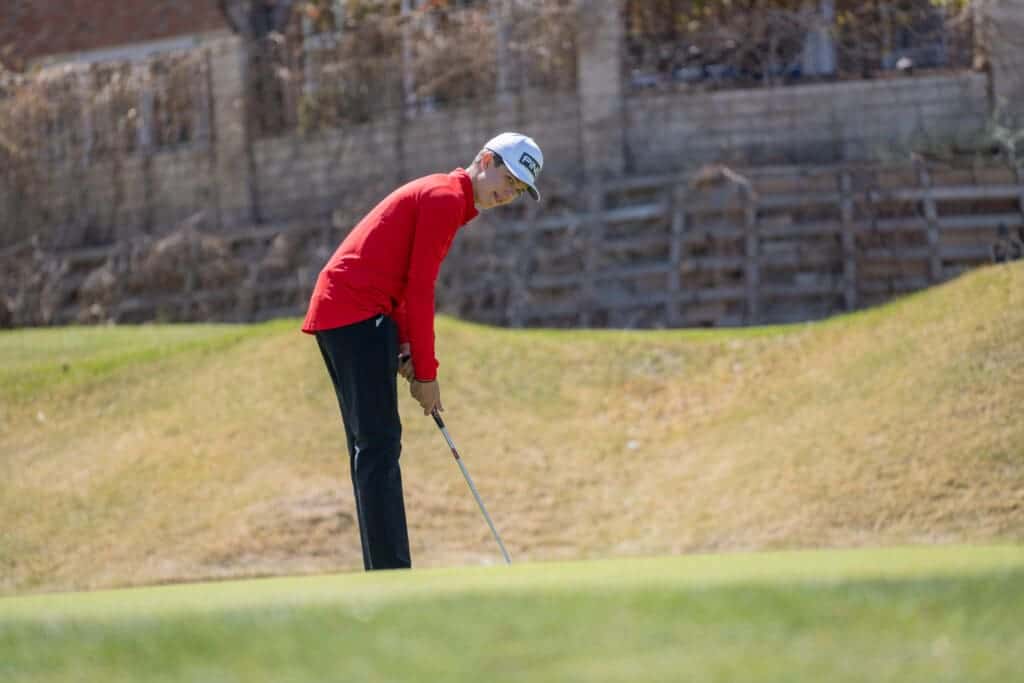 Albuquerque Academy student playing golf on a sunny course.