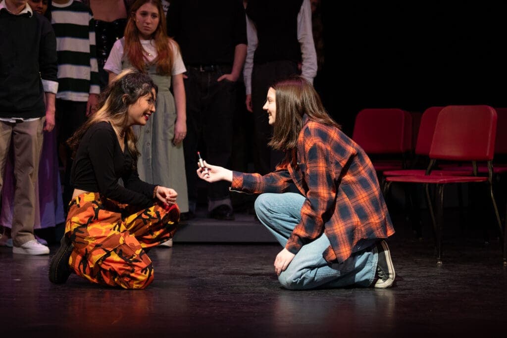 Kissing scene from Albuquerque Academy drama, students performing on stage in a theater.