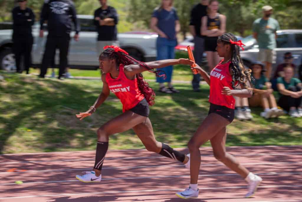 Albuquerque Academy track and field race with young athletes competing outdoors.