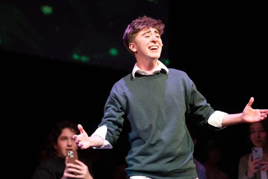 Albuquerque Academy student performing on stage during a theatrical presentation or school event.