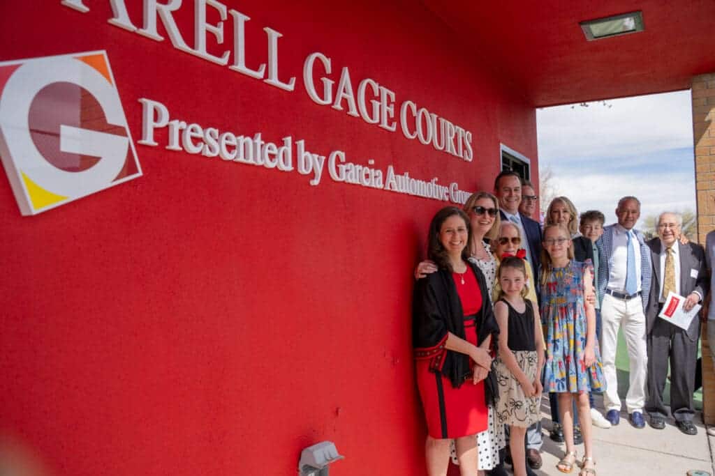 Albuquerque Academy community gathering outside event venue with Albuquerque Gage Courts sign.