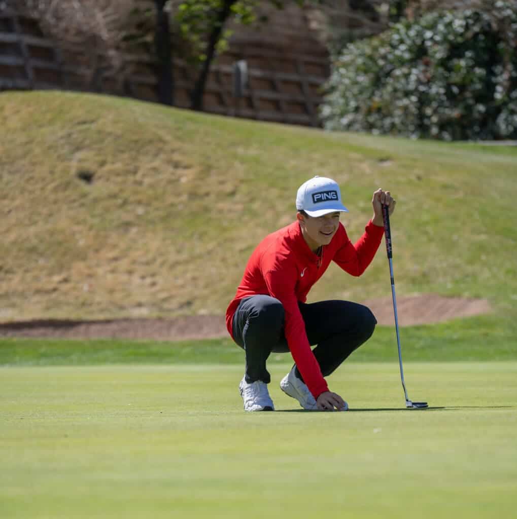 Albuquerque academy student playing golf on a green golf course.