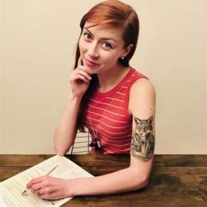 Modern student girl with tattoos studying at Albuquerque Academy classroom or library.