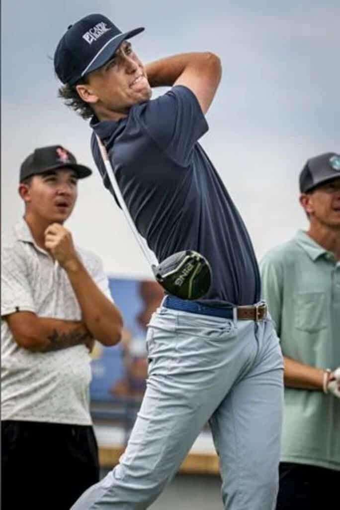 Swinging a golf club at Albuquerque Academy golf course.