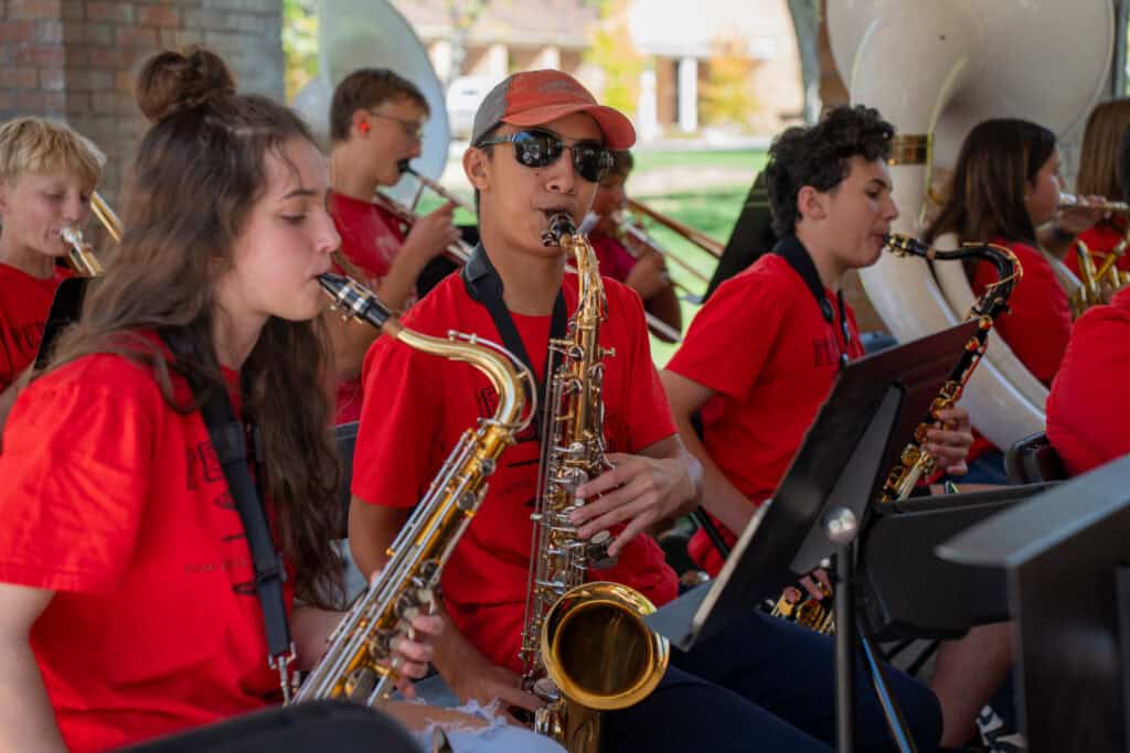 Albuquerque Academy band students performing with saxophones during school event.