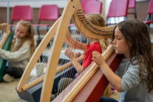 Children playing harp at Albuquerque Academy music class.