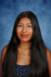 Diverse student portrait at Albuquerque Academy on blue background.