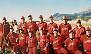 Youth baseball team in red uniforms at Albuquerque Academy sports field for school athletic program.