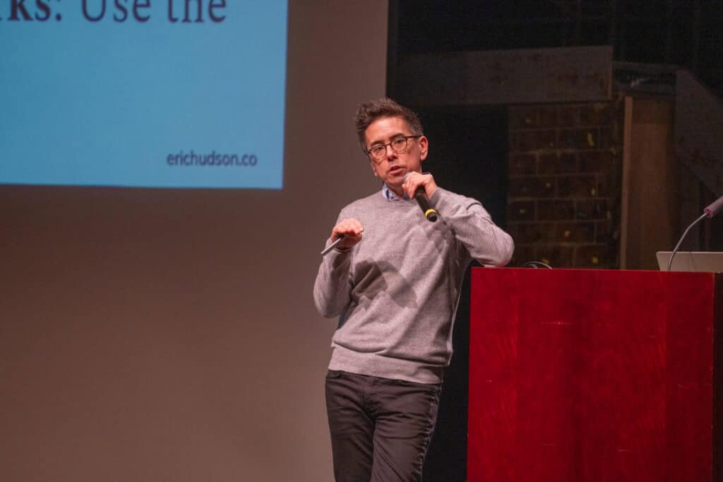 Innovative educator speaking at Albuquerque Academy on AI in education during a presentation.