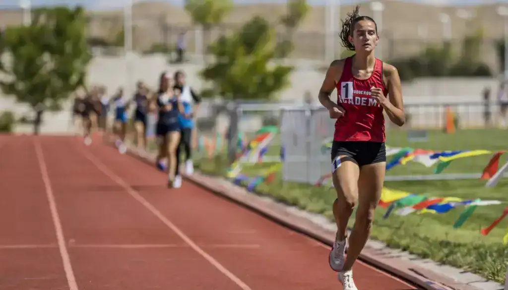 Albuquerque Academy female runner competing in indoor track race in Boston.