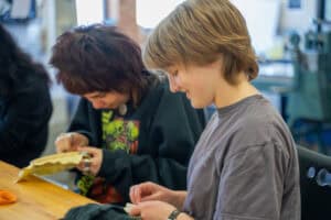 Albuquerque Academy student engaging in art project during visiting artist event.