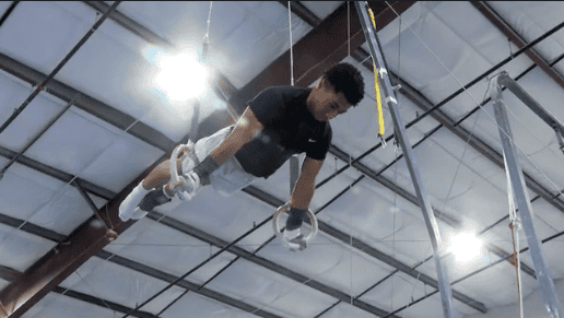 Albuquerque Academy student practicing gymnastics in indoor training facility.