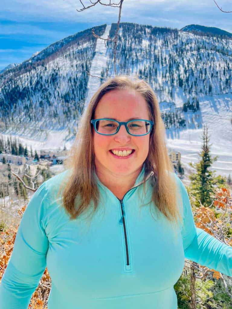 Albuquerque Academy student smiling outdoors with snowy mountain background.