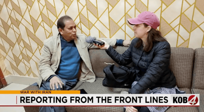 Albuquerque Academy student interviewing a woman in a professional setting for news coverage.