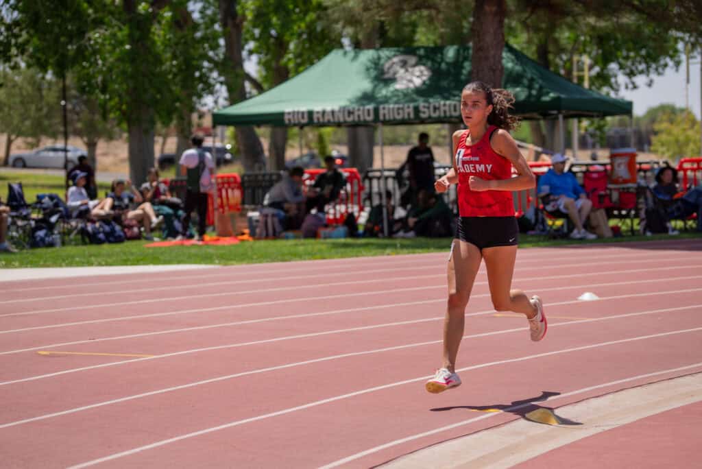 Albuquerque Academy athlete running on track at Chandler invite meet.