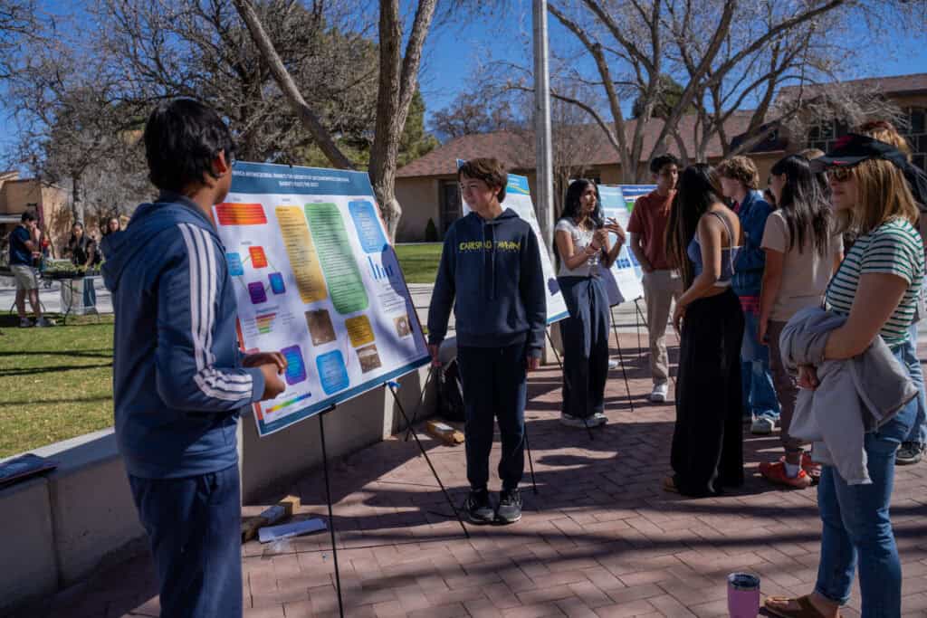 Albuquerque Academy STEM students presenting science projects outdoors on campus.