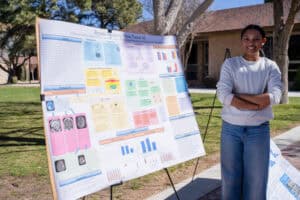 Albuquerque Academy student presenting a science project at outdoor fair.