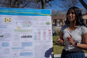 Albuquerque Academy student presenting STEM research at science fair outdoors.