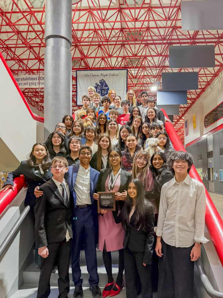 Albuquerque Academy students celebrating academic achievement in a modern school building.