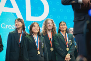 DECA students wearing medals on stage