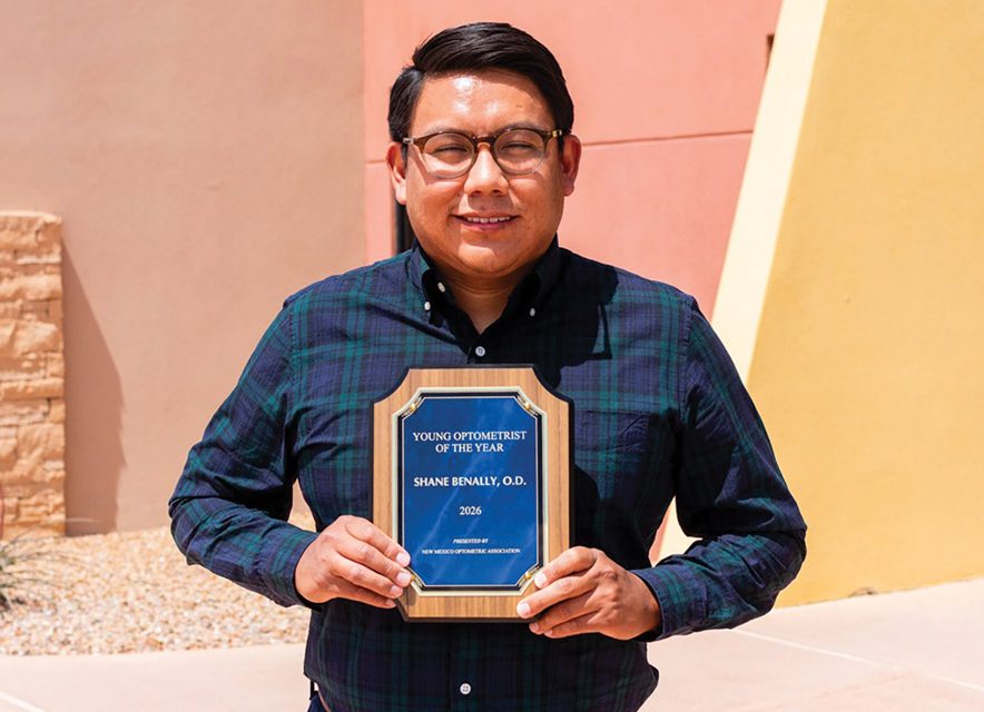 Man holding Young Optometrist of the Year plaque
