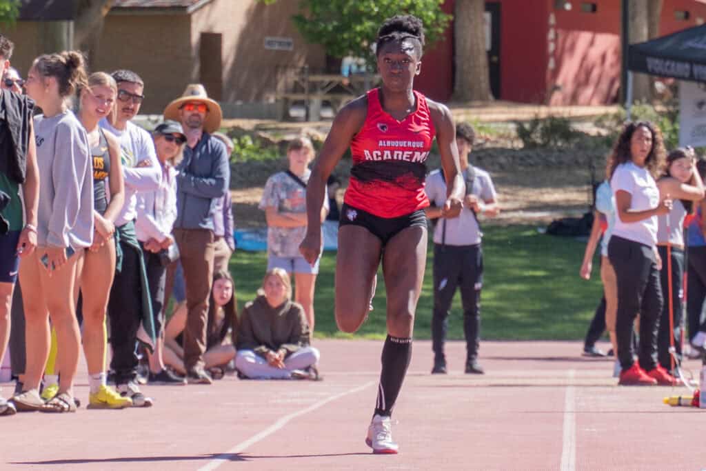Albuquerque Academy student competing in track and field event at school outdoor meet.
