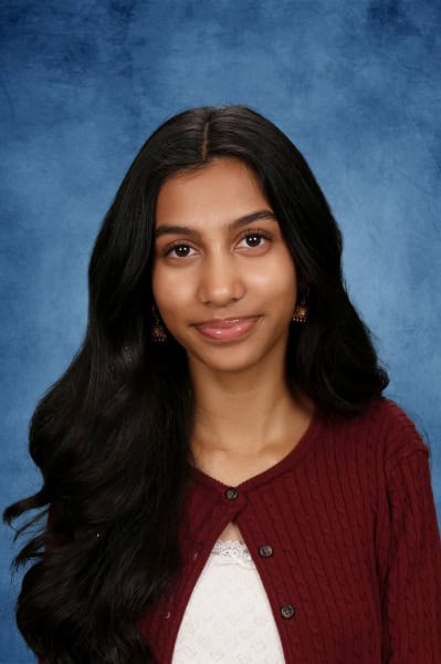Albuquerque Academy student portrait with long dark hair and warm smile.