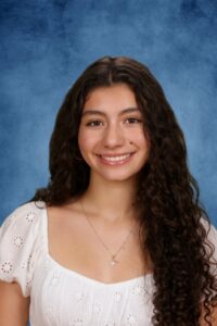 Smiling young woman with curly hair studio portrait