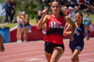 Female sprinter leading race on outdoor track