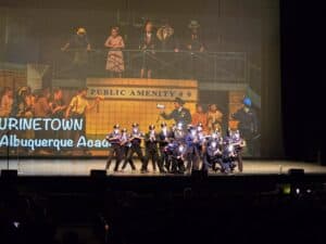 Stage performance of Urinetown with police ensemble