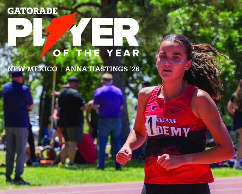 Anna Hastings running at a track meet, wearing a red and black track uniform.