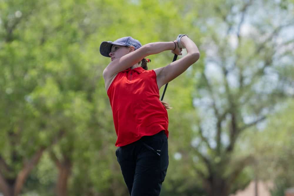 Albuquerque Academy student playing golf outdoors on campus.