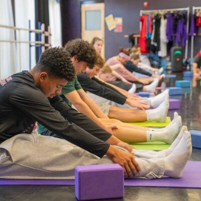Students stretching in a dance or yoga class at Albuquerque Academy.
