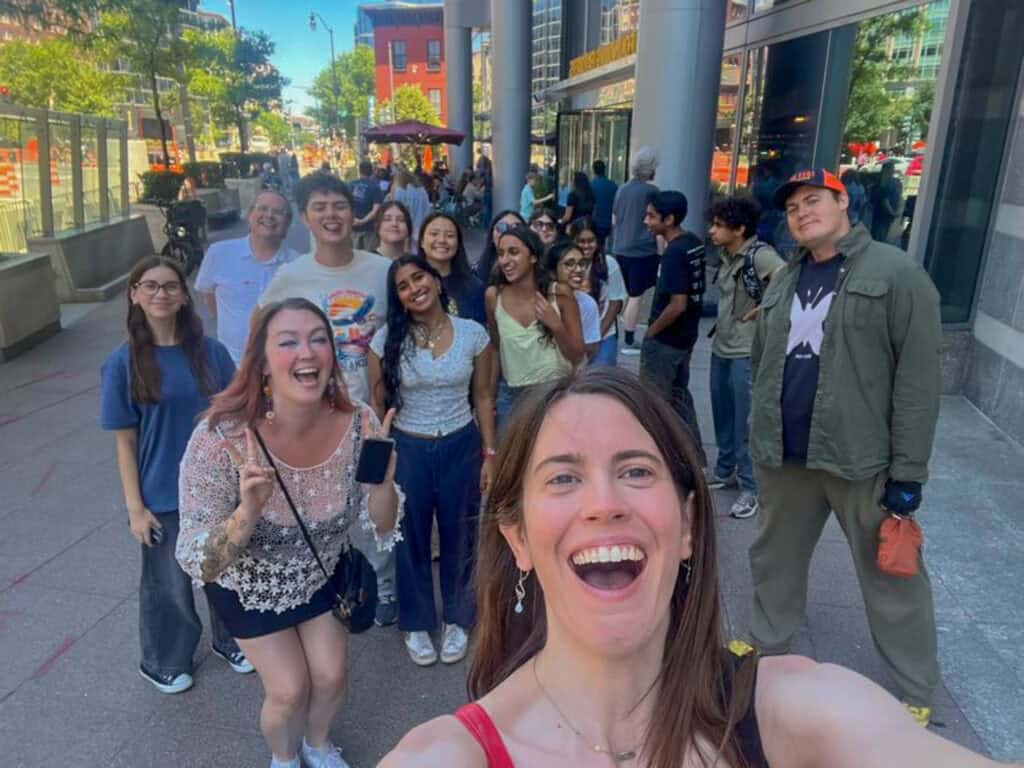 Group of students smiling outside Albuquerque Academy during daytime.