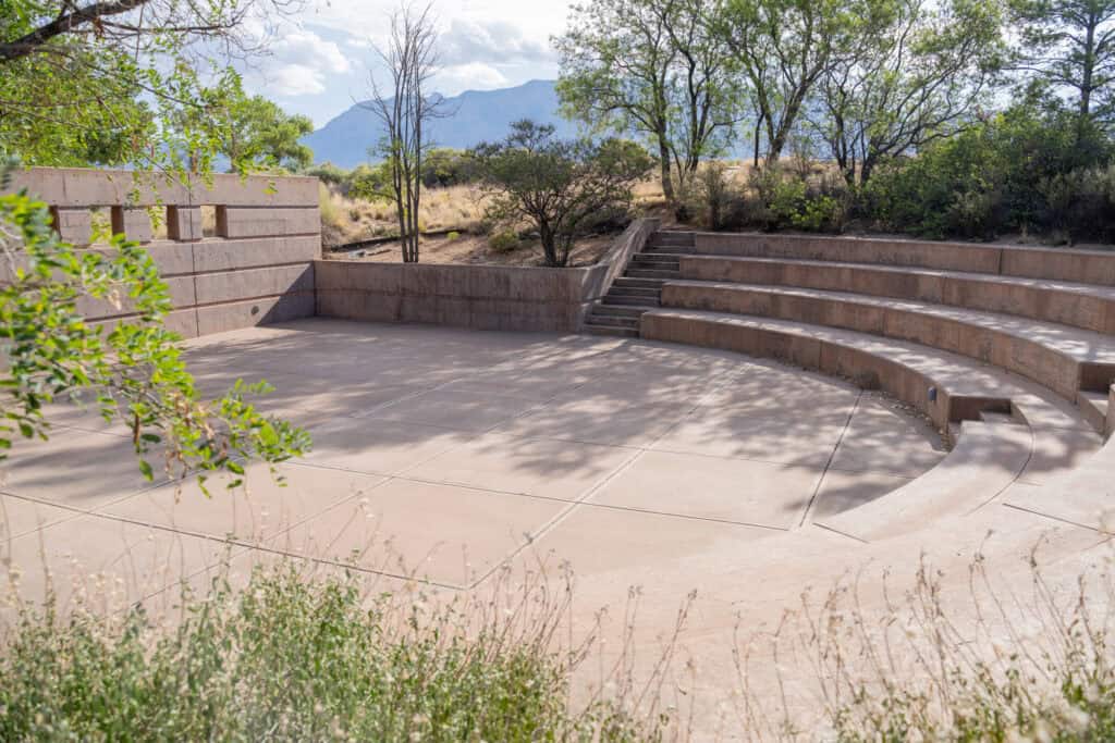 Empty outdoor amphitheater at Albuquerque Academy with mountain view in background.