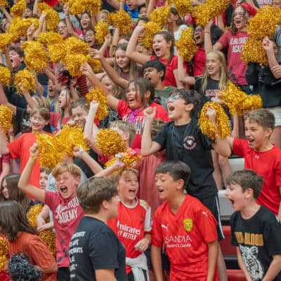 Cheer DSC06866-2 Students at Albuquerque Academy cheer with gold pom-poms during school event.