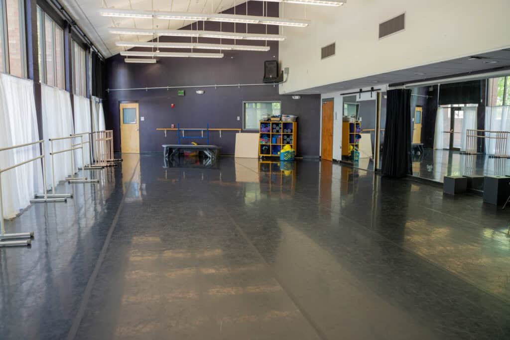 Dance studio at Albuquerque Academy with mirrors, ballet barres, and open floor space.