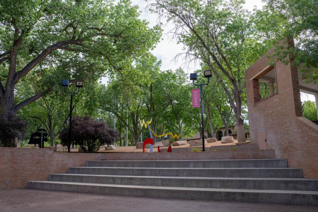 Albuquerque Academy campus with trees, playground, and brick structures in New Mexico.