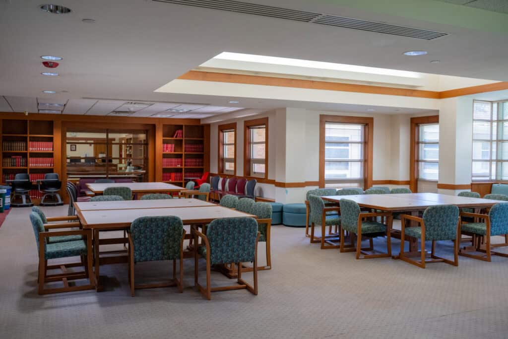 Albuquerque Academy library reading and study area with tables and chairs.