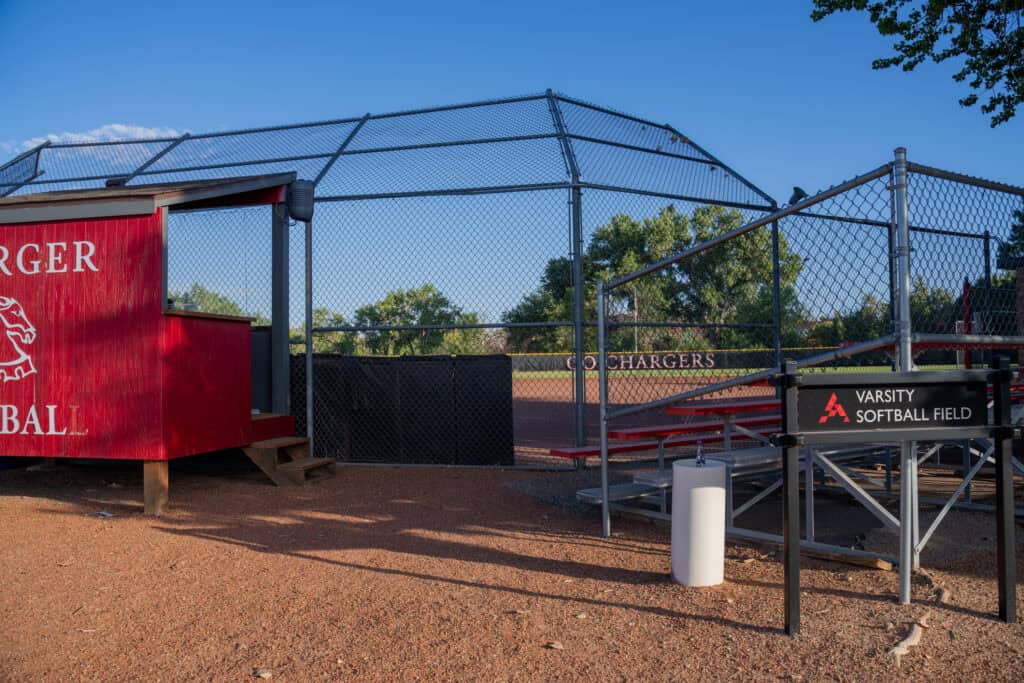 Albuquerque Academy varsity softball field with chain-link fencing and dugout.