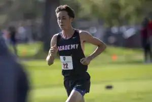 Young male athlete running in a cross-country race at Albuquerque Academy.
