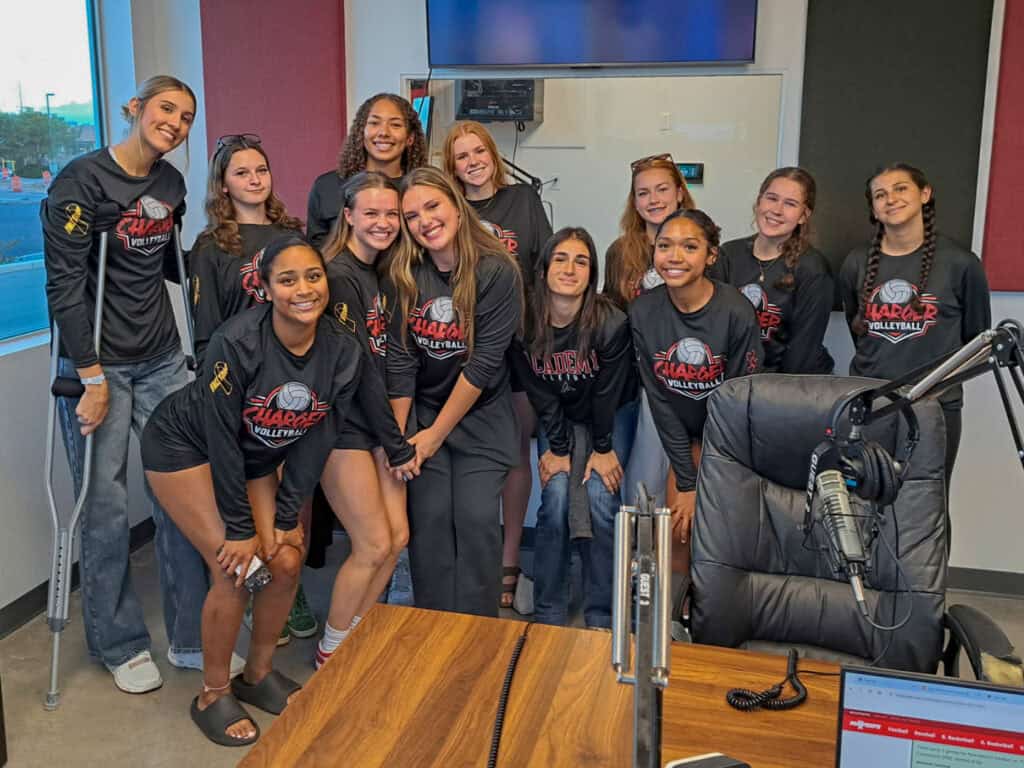 Albuquerque Academy girls' volleyball team in a radio studio for interview or recording session.