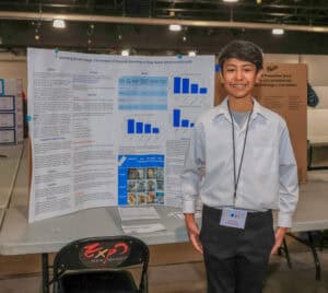Albuquerque Academy student presenting science fair project on climate change impact.